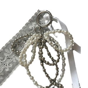 Elegant beaded keychain with white pearls, silver beads, and a silk ribbon bow accessory