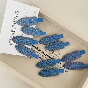 Set of 9 denim texture hair clips with colorful polka dots on a minimalist tray