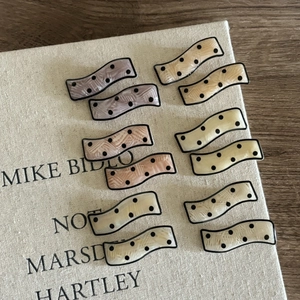 Wavy acetate hair clips with black polka dots in assorted pastel Morandi colors