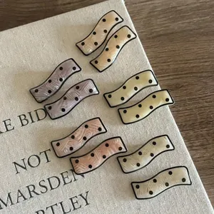 Set of 10 wave-shaped acetate hair clips with polka dots in five macaron colors