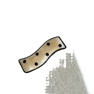 Wavy acetate hair clip with classic black polka dots on cream white translucent material