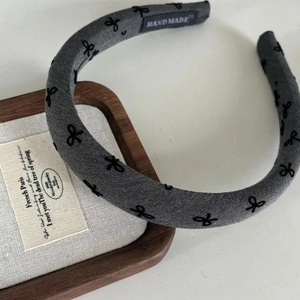 Minimalist handmade bow headband in dark gray linen fabric with a high-crown design