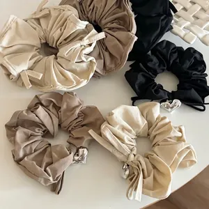Elegant satin scrunchie set in earth tones with stylish silver heart charms