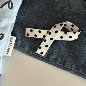 Polka dot bow hair clip with streamer in dark grey and light blue fabric texture