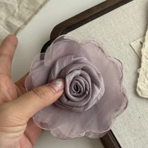 Close-up of elegant dusty purple mesh flower hair claw clip with delicate silk texture