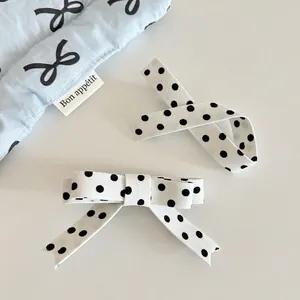 Sweet polka dot bow hair clip set with white fabric and elegant black ribbons for women