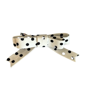 Polka dot ribbon bow hair clip with white fabric and black dots on a metal spring clip