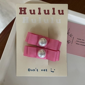 Coppia di dolci fermagli per capelli a fiocco rosa con perle su scheda di presentazione