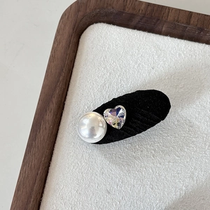 Eleganter Haarclip mit weißer Perle und funkelndem herzförmigem Strass auf Stoffbasis