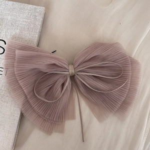 Detail of a large pleated mesh bow hair clip in elegant Morandi brown purple layers