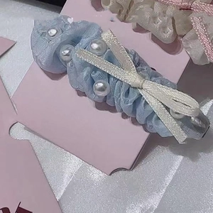 Sweet blue lace hair clip with white pearls and beige ribbon bow on pink card