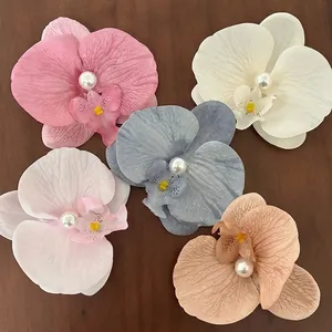 5Pcs realistic orchid flower hair clips with pearls on dark wood surface background