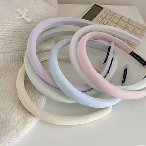 Pastel candy color sponge headbands in cream shades with handmade woven labels