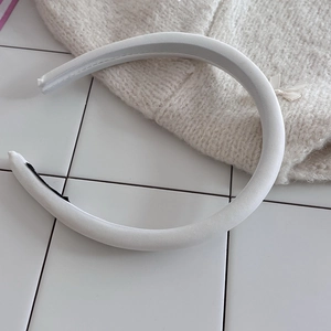 Minimalist white padded sponge headband with soft fabric texture and non-slip design