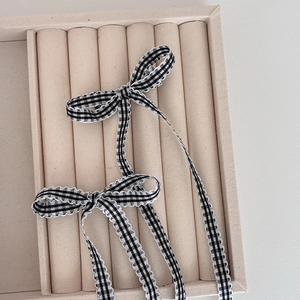 Chic black and white checkered bow hair clips with delicate white lace edging 2-piece set