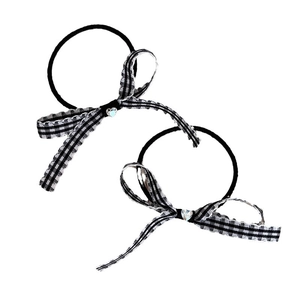 Pair of black and white checkered bow hair ties with sparkling heart rhinestone centers