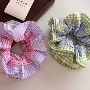 Plaid gingham scrunchies with white lace edges in purple and mint blue colors