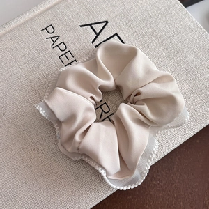 Elegant satin beige scrunchie with lace mesh edges and decorative white faux pearls