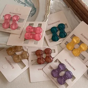 Colorful mini acrylic bow hair clips set on display cards for kids and girls