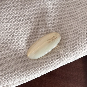 Detailed macro view of cream cellulose acetate hair clip with FRANCE Handmade engraving