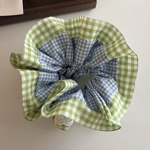 Detail of plaid scrunchie with dual-color green and blue checkers and lace trim