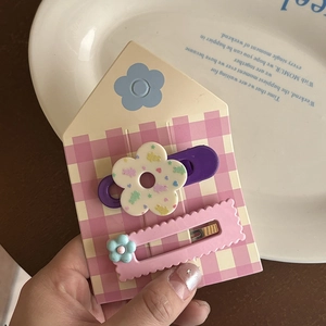 Lot de deux jolies barrettes à motifs ours et fleurs sur une carte de présentation à carreaux