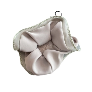Elegant satin scrunchie in light beige fabric with delicate green wavy stitched edges