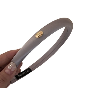 French vintage thick headband with gold logo emblem in grey-purple leather texture