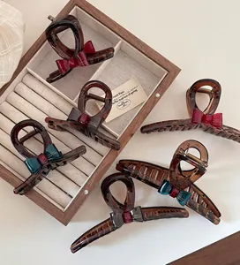 Macro view of vintage style tortoise shell hair clips with elegant silk bow knots