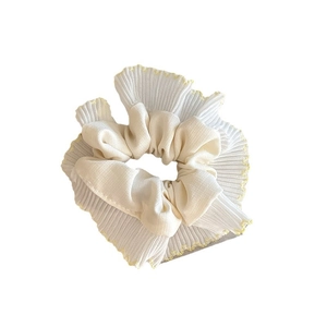 Cream mesh scrunchie hair tie with yellow wavy edge embroidery on white background
