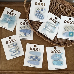 Blue plaid and floral chiffon heart hair clips set displayed on white cards