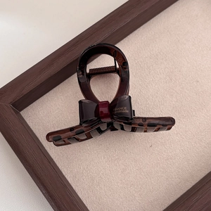 Detail of tortoise shell hair claw with bow and France Handmade gold lettering