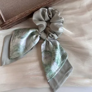 Elegant Monet water lily print sage green satin scrunchie with flowing silk ribbons