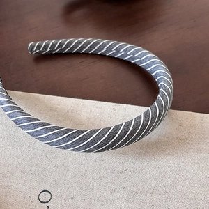 Close-up of grey striped fabric texture on minimalist sweet style headband