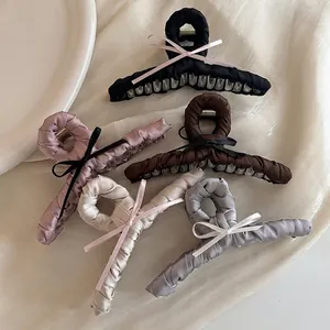 Set of five elegant satin ribbon bow hair claw clips in assorted soft pastel colors