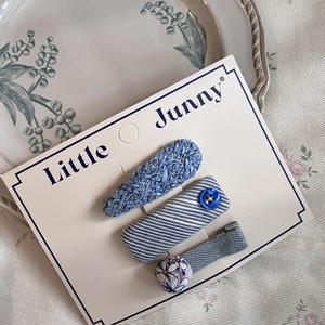 Detailed set of blue plaid and striped bow hair clips on a white presentation card