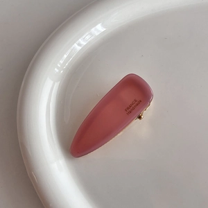 Pink acetate triangle hair clip with France Handmade gold text on white ceramic tray