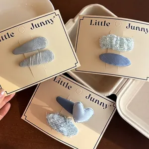 Blue plaid heart hair clips set with star denim and bow designs on display card