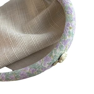 Floral camellia sponge headband with purple fabric texture and golden metal logo tag