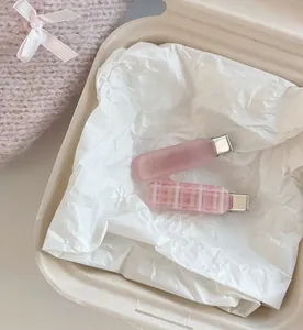 Close-up of pink checkered and matte resin hair clips set in a soft ins-style aesthetic
