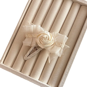 Cream white fabric rose hair clip with mesh bow details and braided ribbon accents