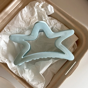 Sky blue starfish shaped hair claw clip in a gift box with aesthetic white paper