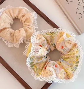Close-up of floral and lace trim scrunchies set on a wooden display for hair styling
