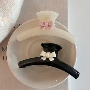 Sweet ribbon bow hair claws in black and white glossy resin for thick hair