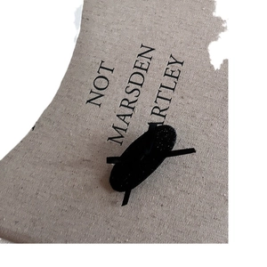 Minimalist black ribbon bow hair clip for women with vintage aesthetic on linen background