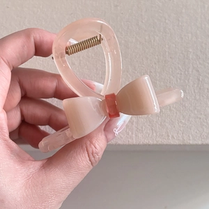 Elegant jelly pink acetate bow hair claw clip with orange accent for women