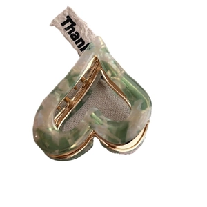 Elegant gold metal hair claw with green and white marble heart acetate pattern