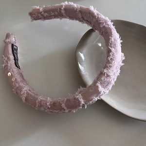 Pink sequin padded headband with distressed edges and elegant shimmering fabric design