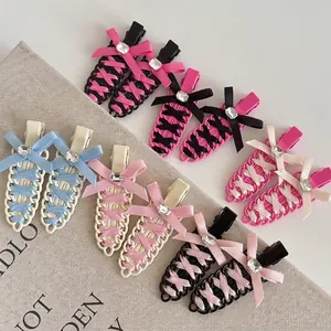 Ballet-style seamless hair clips with ribbon corset design and heart rhinestone accents