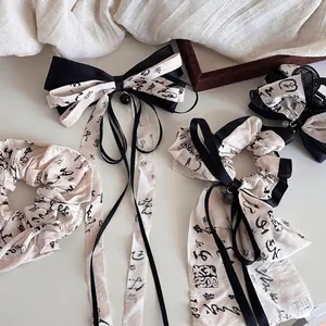 Ink wash style hair accessory set with scrunchie and bow clip in calligraphy linen
